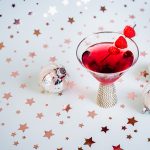Red Electra Moscato Martini with a star background and silver ornaments