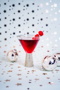 Electric Berry Moscato Martini with a raspberry garnish and ornaments