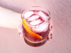 Elysium Sour Cocktail with lemon peel garnish