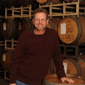 Darin Peterson in front of wine barrels at Quady Winery in Madera, California.