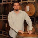 Dave Glover in front of wine barrels at Quady Winery in Madera, California.