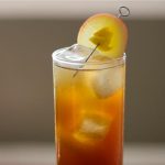 Fall Fizz with Quady Vya Sweet Vermouth in a high ball glass with a Apple slice garnish