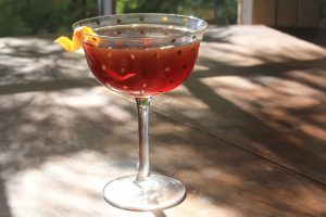 Senor Martinez cocktail in a coupe glass with an orange twist garnish.