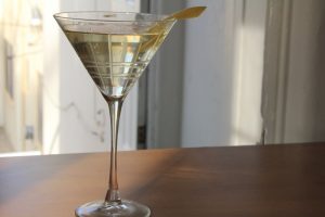 Reverse Martini cocktail in a martini glass and a lemon peel garnish.