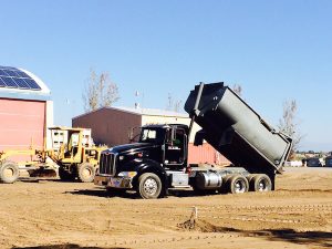 Dump truck at Quady Winery unloading dirt.