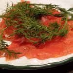 Salmon lochs on a dish with a garnish.
