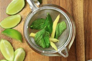 Basil and lime straining into a dish.