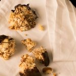 Chocolate Dipped Almond Macaroons on a napkin.