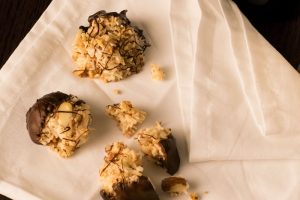 Chocolate Dipped Almond Macaroons on a napkin.
