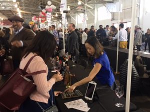Quady employee at the san francisco chronicle wine competition and tasting pouring Quady sweet wine for attendees to taste.