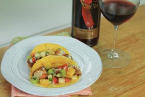AHI TACOS & KIWI-TANGERINE SALSA on a plate with a glass and bottle of Red Electra Moscato wine behind it.