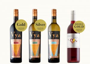 Vya Sweet Vermouth, Vya Extra Dry Vermouth, Vya Whisper Dry Vermouth and Elysium Black Muscat Dessert wine in a row with various awards and medals present.