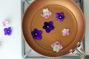Edible flowers sitting in a pan with Vya Extra Dry Vermouth.