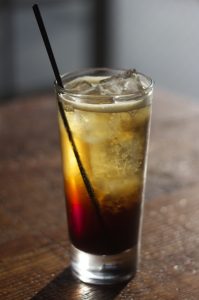 Classic Americano Royale cocktail with Vya Sweet Vermouth in a highball glass with ice and a straw.