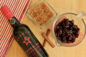 Bottle of Starboard Batch 88 Port Wine next to brown sugar, dried cranberries and cinnamon sticks.