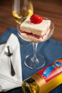 Creamy Strawbery Electra Moscato Wine Torte Dessert Recipe Pairing with bottle of Quady Electra Moscato and wine glass.
