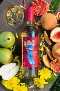 Electra Moscato wine bottle with new packaging surrounded by flowers, peaches, pears and wine glass.