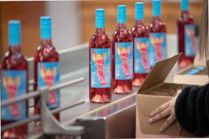 2019 vintage Electra Moscato Rose on the bottling line being packed into wine case boxes.