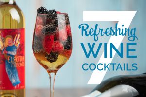 7 Refreshing Wine Cocktail text over a wine glass filled with Electra Moscato, Fresh Fruit and Prosecco