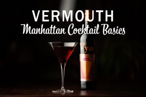 A manhattan cocktail in a martini glass next to a bottle of Vya Sweet Vermouth against a black background underneath text that reads, "Vermouth, Manhattan Cocktail Basics."