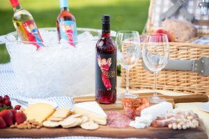 Red Electra Moscato wine in a picnic setting under the spring sun.