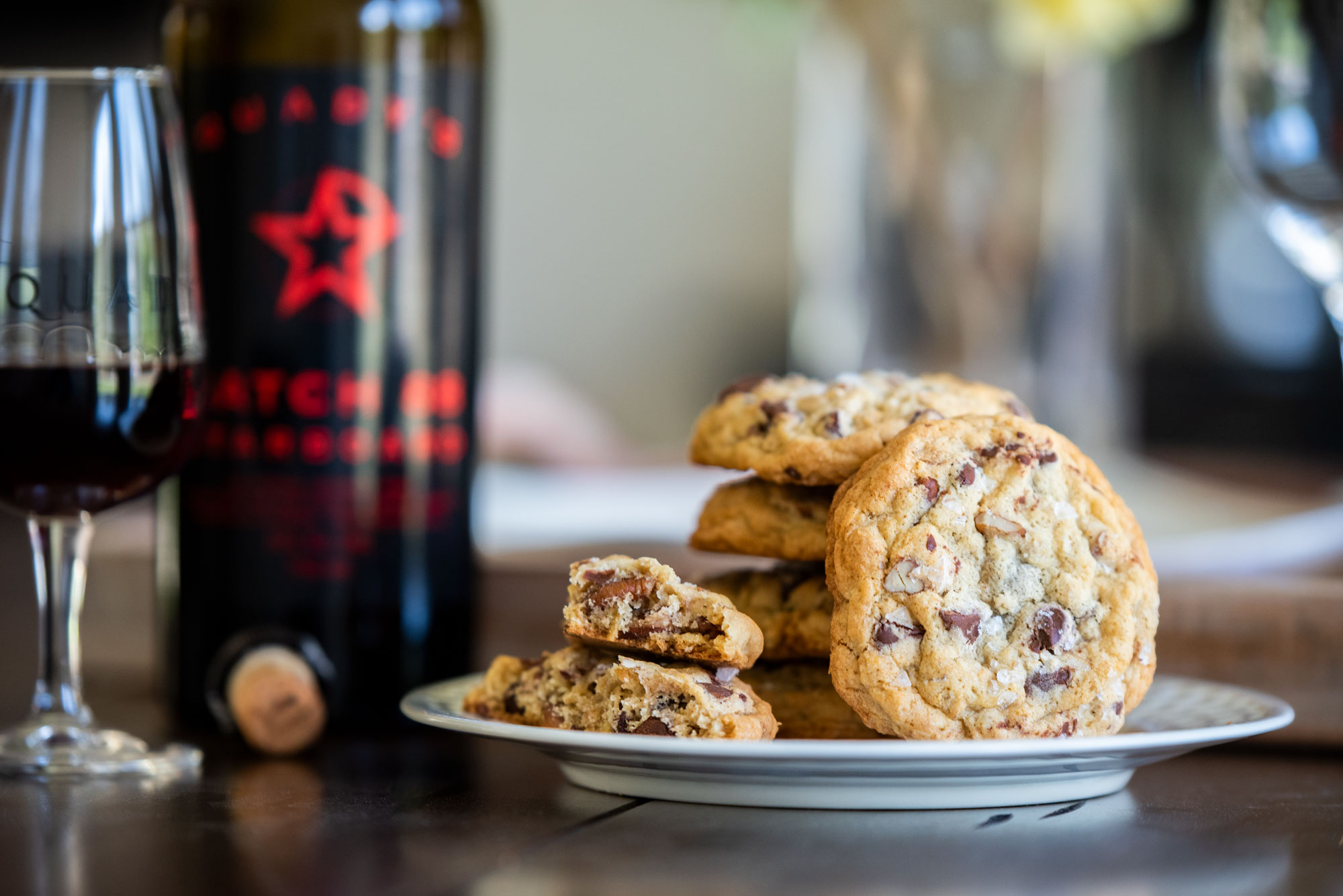 Sarah's famous chocolate chip cookies on a plate next to a bottle of Quady's Starboard Batch 88 port style wine.