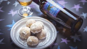 Pfeffernusse cookies with a bottle and a glass of Deviation dessert wine