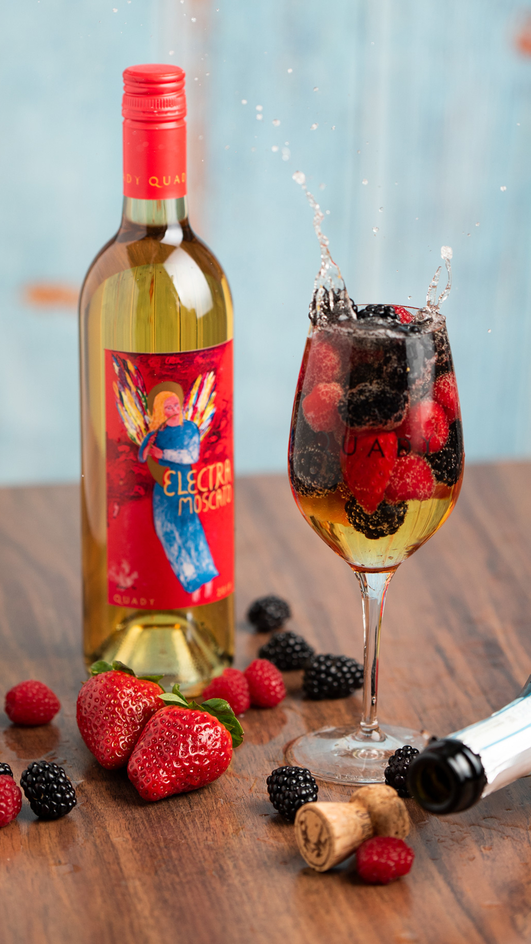 Prosecco next to Electra bottle with berries.
