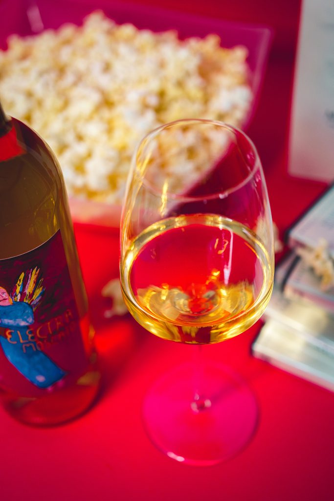 Glass of Electra Moscato with popcorn