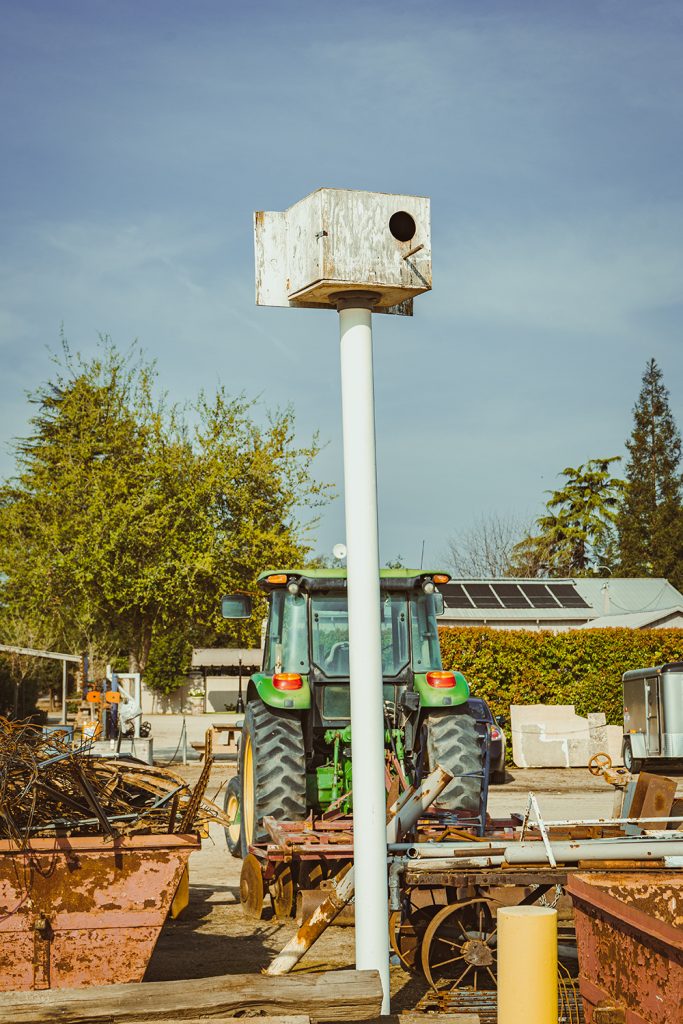 Owl box by a tractor and farm equipment
