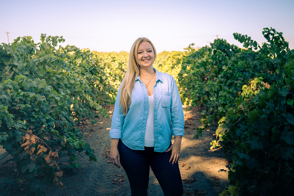 Winemaker Crystal Weaver-Kiessling standing in a vineyard
