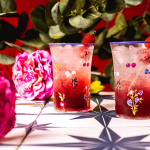 Raspberry Lemonade Moscato Spritzers with flowers and plants in the background