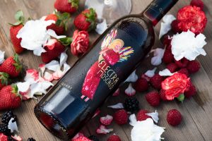 Red Electra Moscato surrounded by fresh berries and flowers