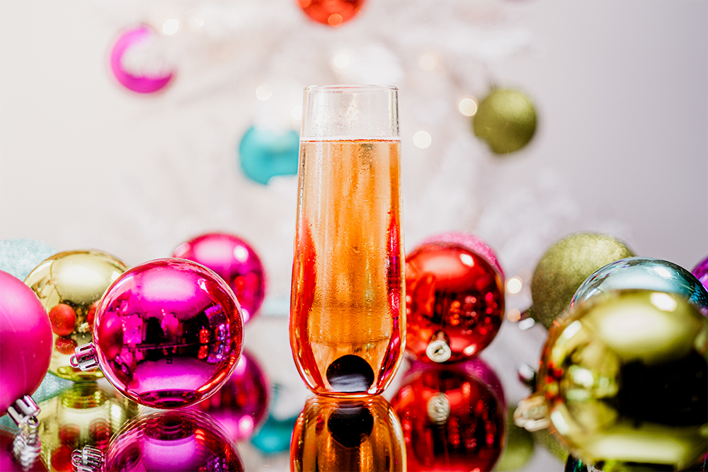 Haute Holiday sparkling wine cocktail with colorful ornaments.