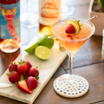 Pink Lady cocktail with strawberries, limes, Electra Moscato Rosé and Essensia Orange Muscat.