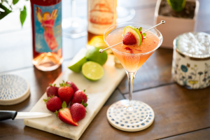 Pink Lady cocktail with strawberries, limes, Electra Moscato Rosé and Essensia Orange Muscat.