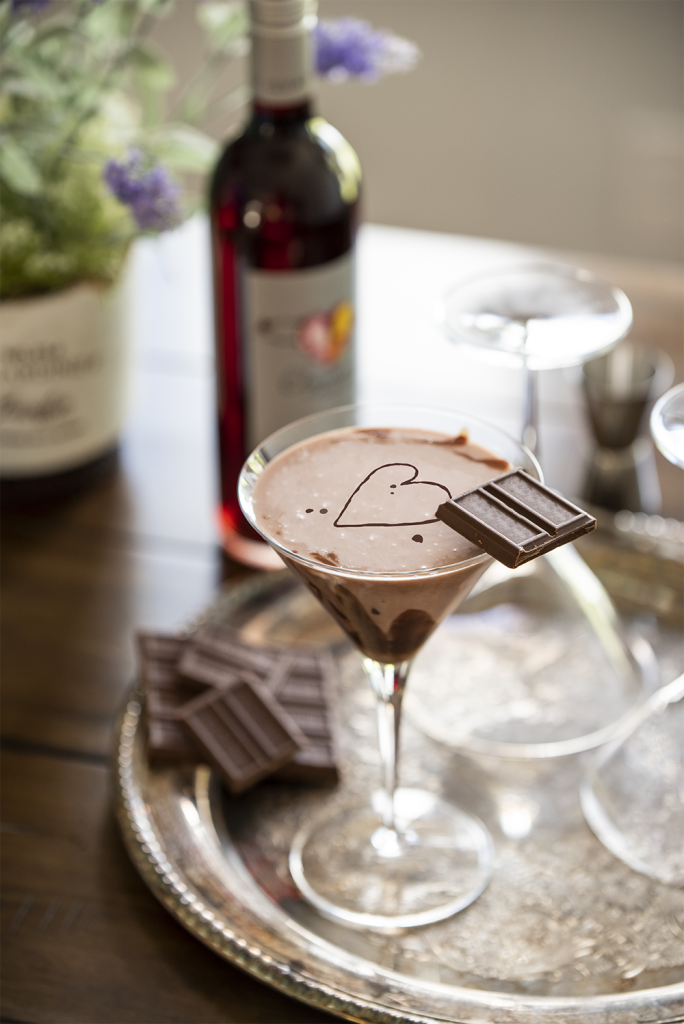 Cherry Chocolate Martini with chocolate garnishes and a bottle of Elysium Black Muscat.
