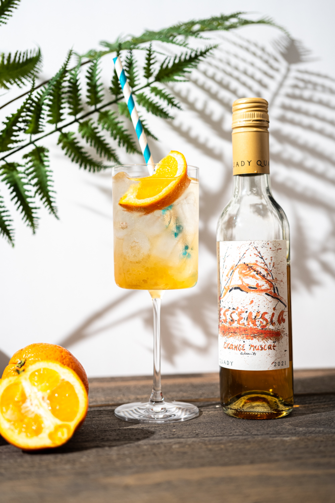Essensia Spritz dessert wine cocktail with bottle of Essensia